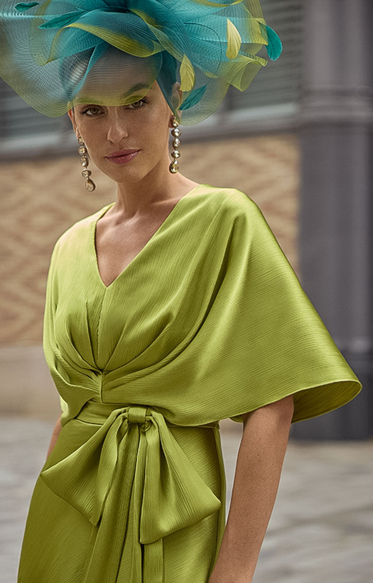 Woman wearing Couture Club 2G07 - Citrus Satin Occasion Dress with Contemporary Elegant Styling with a large teal and yellow hat.