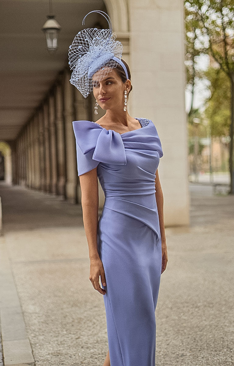Woman in Couture Club 2G15 - Lavender Crepe Occasion Dress with Timeless Feminine Elegance with a matching headpiece standing outdoors.