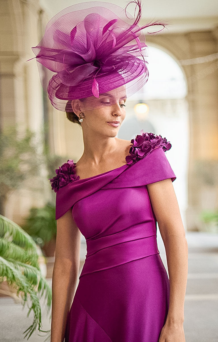 Woman wearing Couture Club 2G26 - Aubergine Crepe and Satin Occasion Dress with Elegant Tailored Silhouette in a beautiful courtyard setting with large potted plants. 