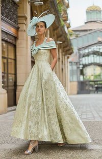 Woman wearing Couture Club 2G35 - Matcha Brocade Occasion Dress with Structured Silhouette mother of the bride / groom dress in an elegant street setting.