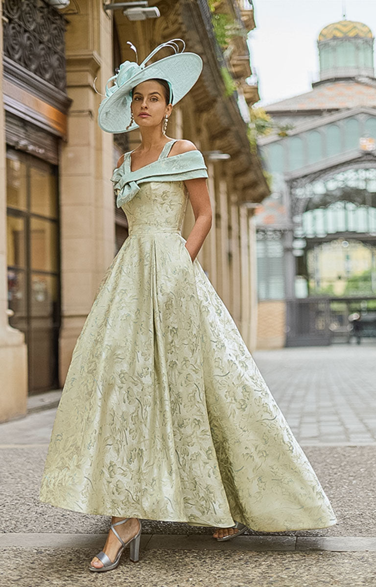 Woman wearing Couture Club 2G35 - Matcha Brocade Occasion Dress with Structured Silhouette mother of the bride / groom dress in an elegant street setting.