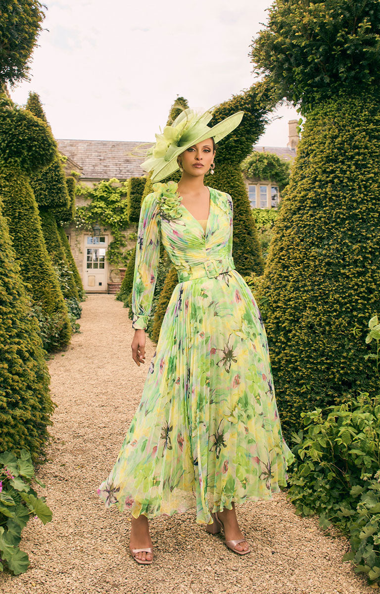 Woman wearing Veni Infantino 992770 - Lime / Multi A-Line Satin Dress with 3D Ruffle Shoulder standing in a garden path with greenery around.