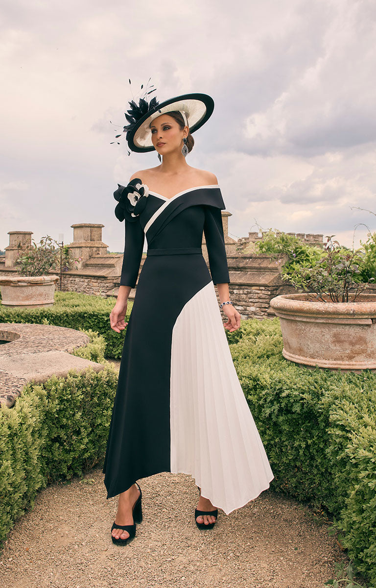 Woman wearing Veni Infantino 992784 - Black / Ivory Asymmetrical A-Line Mother of the Bride Dress with 3D Floral Detail in a beautiful, landscaped country house garden. 